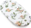 A white oval-shaped baby mattress cover with a savanna-themed print of cartoon animals and leaves. Produktbild-Vorschau