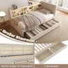 A bed with storage drawers and a bookshelf headboard, shown in a bedroom setting. Produktbild-Vorschau