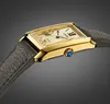 A close-up, side view of a gold-toned rectangular watch with a cream-colored face and a gray leather strap, set against a gradient gray background. Podgląd zdjęcia produktu