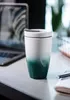 A ceramic travel mug with a gradient color from white to teal sits on a desk next to a laptop and notebook. Voir les images du produit