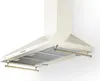 A cream-colored kitchen range hood with gold accents, shown against a white background. Produktbild-Vorschau