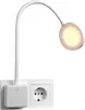 A white LED lamp with a flexible neck is plugged into a white wall socket. The lamp head is illuminated. Anteprima dell’immagine prodotto