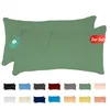 Two green pillowcases are shown, one partially covering the other, with a tag attached to the top pillowcase. Below the pillowcases, a row of smaller pillowcase swatches in various colors is displayed. Produktbild-Vorschau