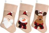 Three Christmas stockings with different designs (Santa, Snowman, Reindeer) are displayed side-by-side against a white background. Produktbild-Vorschau