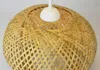 A close-up view of a woven bamboo pendant light fixture. Produktbild-Vorschau