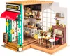 A miniature diorama of a coffee shop called Simon's Coffee. Anteprima dell’immagine prodotto