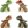 A collage of four different dinosaur toys, each in a different color. Anteprima dell’immagine prodotto