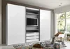 A modern white wardrobe with a TV element integrated into the center, set in a well-lit room with a large window and decorative elements. Anteprima dell’immagine prodotto