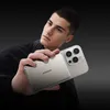 A young man is holding a power bank and a smartphone. Produktbild-Vorschau