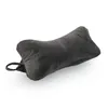 A dark gray bone-shaped pillow is shown on a white background. Produktbild-Vorschau
