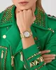 A woman wearing a green studded jacket and a gold watch. Podgląd zdjęcia produktu