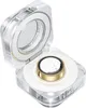 A close-up, angled view of an open, clear square case containing a gold and white ring. Anteprima dell’immagine prodotto