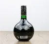 A dark glass bottle of Unicum Kräuterlikör sits on a wooden surface against a white background. Produktbild-Vorschau