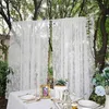 A table setting with white lace curtains in the background, outdoors among trees. Produktbild-Vorschau