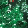 Close-up of green Christmas tree branches adorned with white LED micro string lights. Voir les images du produit