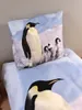 A close-up view of a bed with a pillow and duvet cover featuring a penguin print. Náhľad obrázku produktu