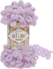 A ball of purple yarn with loops, sitting on top of its packaging. Náhled obrázku produktu