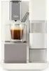 A close-up shot of a white and gray coffee machine with a glass of espresso. Produktbild-Vorschau
