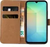 A brown leather flip case for a smartphone, showing credit cards and banknotes inside. Produktbild-Vorschau