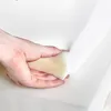 A hand is pressing into a white foam material. Anteprima dell’immagine prodotto