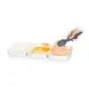 A hand is using tongs to place a breaded piece of food into a tray of breadcrumbs. There are three trays in a row: one with flour, one with beaten eggs, and one with breadcrumbs. Náhľad obrázku produktu