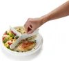 A hand is shown placing food into a divided plate. Produktbild-Vorschau