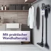 A vacuum cleaner is mounted on a wall in a laundry room setting, with a white shirt hanging nearby. Produktbild-Vorschau