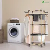 A laundry room scene with a washing machine and a drying rack. Produktbild-Vorschau