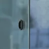 A close-up of a black recessed handle on a frosted glass door. Produktbild-Vorschau