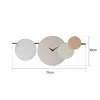 A wall clock with abstract circular elements and measurement indicators. Produktbild-Vorschau
