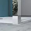 A close-up view of a modern shower enclosure, showing the base and a corner of the glass door with a chrome frame. Produktbild-Vorschau