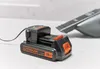 A Black & Decker Dustbuster battery and charger are shown on a countertop. Anteprima dell’immagine prodotto