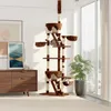 A tall cat tree with multiple platforms, perches, and scratching posts, placed in a living room setting next to a window and a dresser. Produktbild-Vorschau