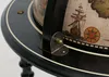 A close-up view of a vintage-style globe bar, focusing on the decorative elements and mounting hardware. Anteprima dell’immagine prodotto