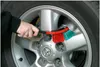 A person is cleaning a car wheel with a brush. Produktbild-Vorschau