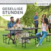 People enjoying a picnic or gathering outdoors at a table and benches. Produktbild-Vorschau