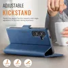 A blue leather phone case is shown in a kickstand position, with a person holding a mug in the background. Produktbild-Vorschau