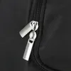 A close-up view of two silver zipper pulls on a black fabric surface. Náhľad obrázku produktu