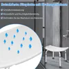 A shower stool in a shower with water running from the shower head. Produktbild-Vorschau