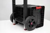 A close-up view of the bottom section of a black rolling tool cart with large wheels. Anteprima dell’immagine prodotto