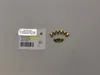 A label and several gas nozzles are arranged on a light gray surface. Produktbild-Vorschau