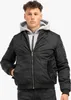 A man wearing a black bomber jacket over a gray hoodie. Produktbild-Vorschau