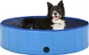 A dog is sitting in a blue foldable dog pool. Voir les images du produit