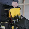 A person is holding a Stanley FatMax tool backpack, with various tools visible inside. Voir les images du produit