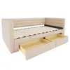 A beige upholstered daybed with two open drawers underneath, shown from a three-quarter angle against a white background. Náhled obrázku produktu