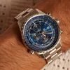 A close-up shot of a man's wrist wearing a silver and blue Casio Edifice watch. Produktbild-Vorschau