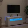 A white TV stand with blue LED lighting is shown in a living room setting, with a TV mounted on the wall above it. Produktbild-Vorschau