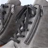 Close-up of grey leather boots with laces and zippers. Produktbild-Vorschau
