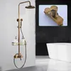 A vintage-style shower fixture with a showerhead, handheld shower, soap dispenser, and shelf, shown in a bathroom setting with a bathtub in the background. A close-up of the faucet is also shown in an inset. Náhľad obrázku produktu