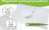 A folded white duvet with care instructions and allergy information displayed. Produktbild-Vorschau